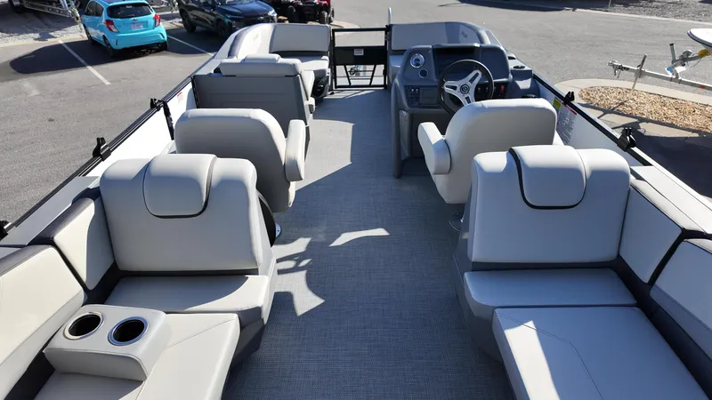 Slide: The Image of 2025 Sylvan A-22 LZ DH pontoon boat interior with plush seating and modern helm. - 10