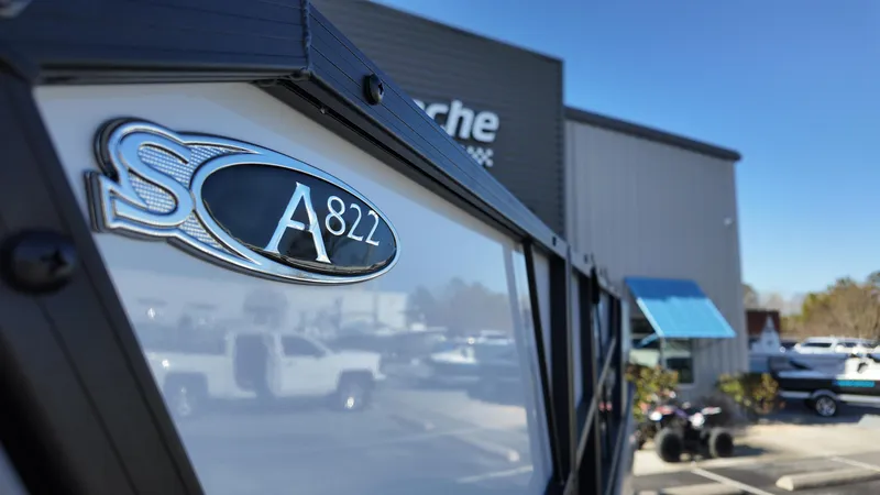 Slide: The Image of 2025 Sylvan A-22 LZ DH boat at dealership, close-up of model emblem. - 3