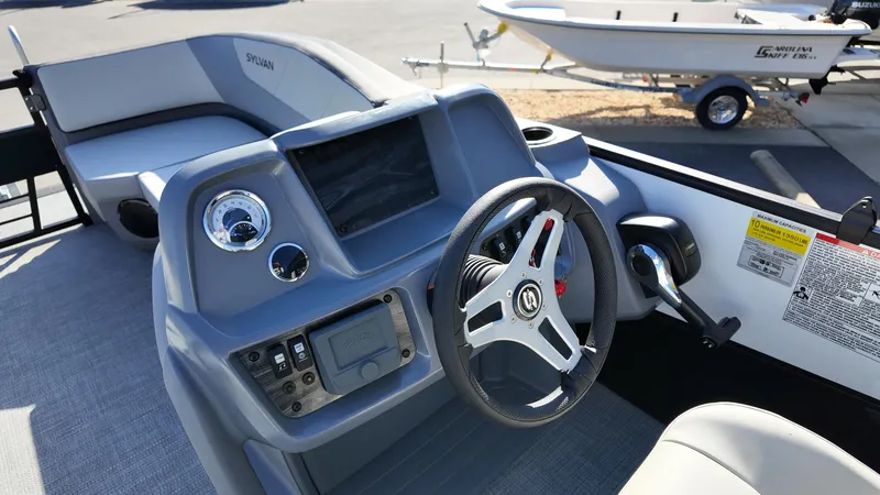 Slide: The Image of 2025 Sylvan A-22 LZ DH boat dashboard with steering wheel and control panel. - 7