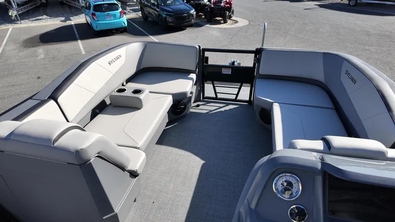 Slide: The Image of 2025 Sylvan A-22 LZ DH pontoon boat with spacious seating and modern design in a parking lot. - 8