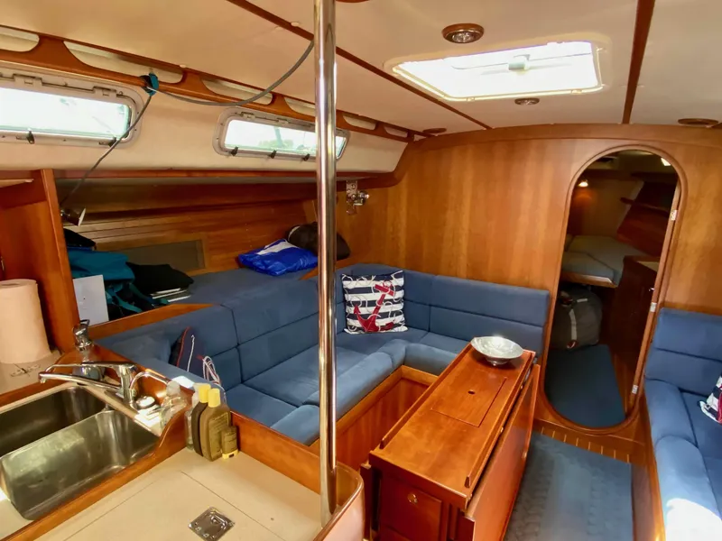 Slide: The Image of Interior of 2001 J Boats J/46 yacht with blue seating and wooden finishes. - 12