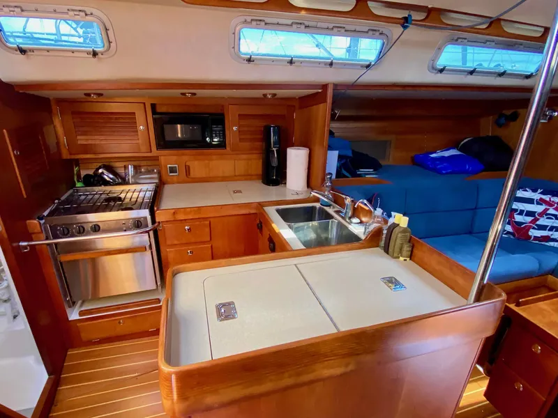Slide: The Image of Interior of 2001 J Boats J/46 yacht with kitchen and seating area. - 13