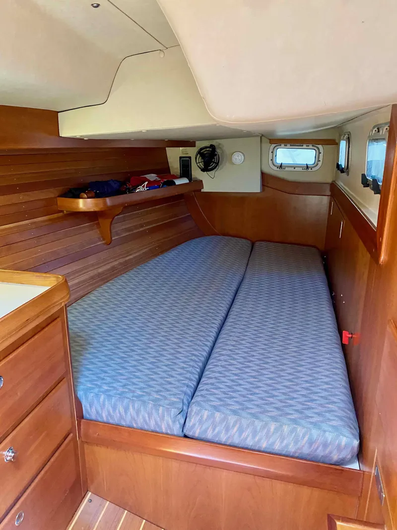 Slide: The Image of Interior cabin of 2001 J Boats J/46 with wooden finish and comfortable bedding. - 16