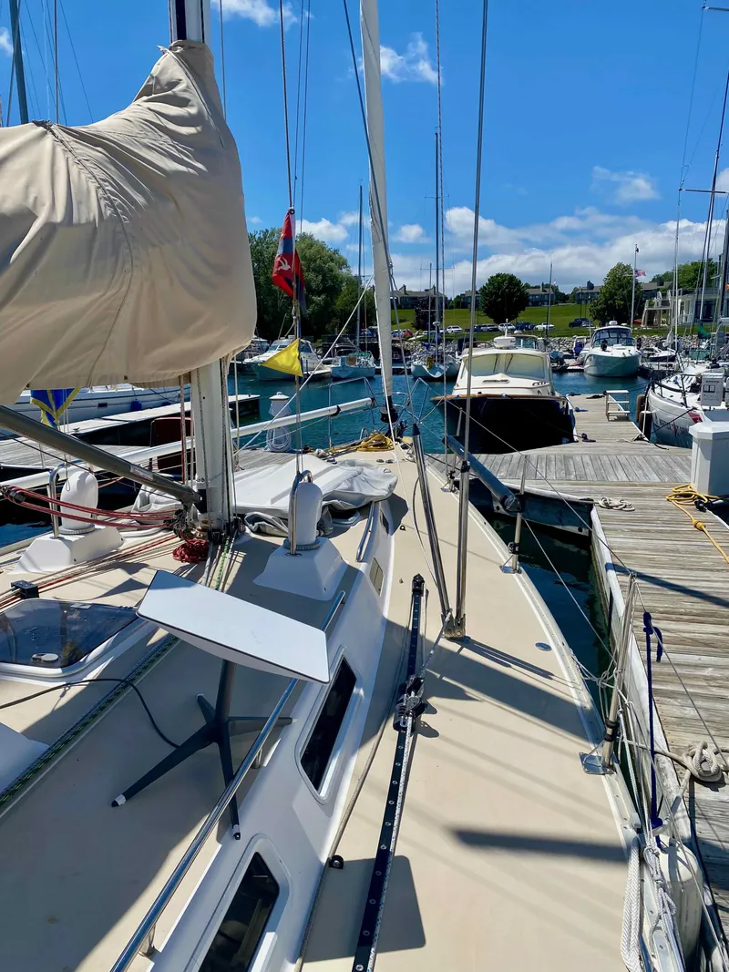 Slide: The Image of 2001 J Boats J/46 sailboat docked at marina under clear blue sky. - 21