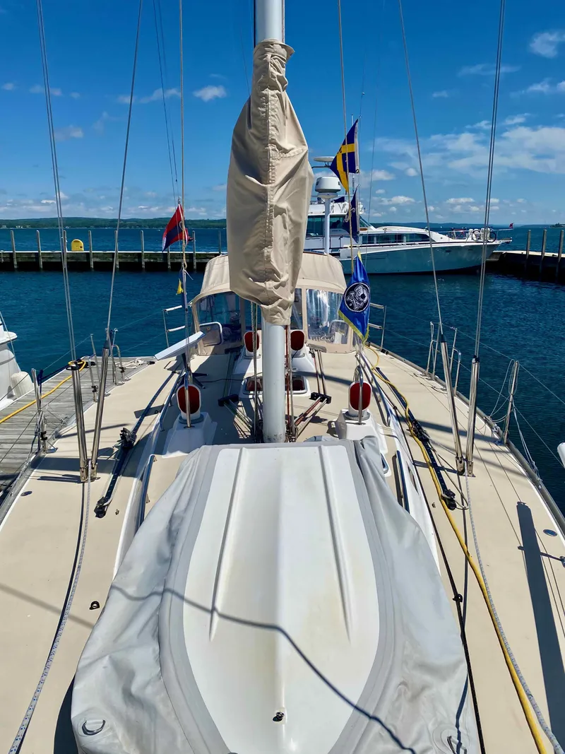 Slide: The Image of 2001 J Boats J/46 sailboat docked at marina under clear blue sky. - 22
