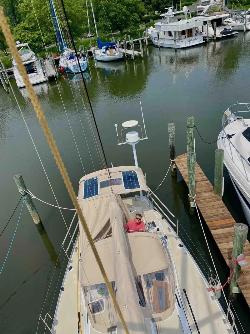 Slide: The Image of 2001 J Boats J/46 sailboat docked at marina with solar panels and scenic surroundings. - 24