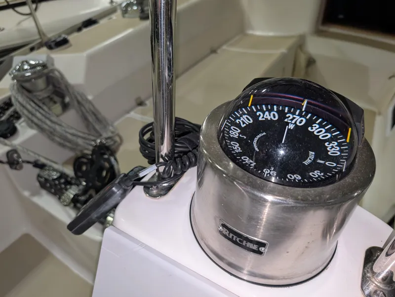 Slide: The Image of Compass on 2001 J Boats J/46 sailboat, featuring navigation equipment and cockpit details. - 33