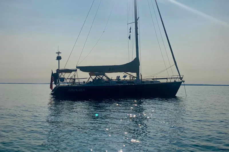 Slide: The Image of 2001 J Boats J/46 sailboat on calm water at sunset. - 4