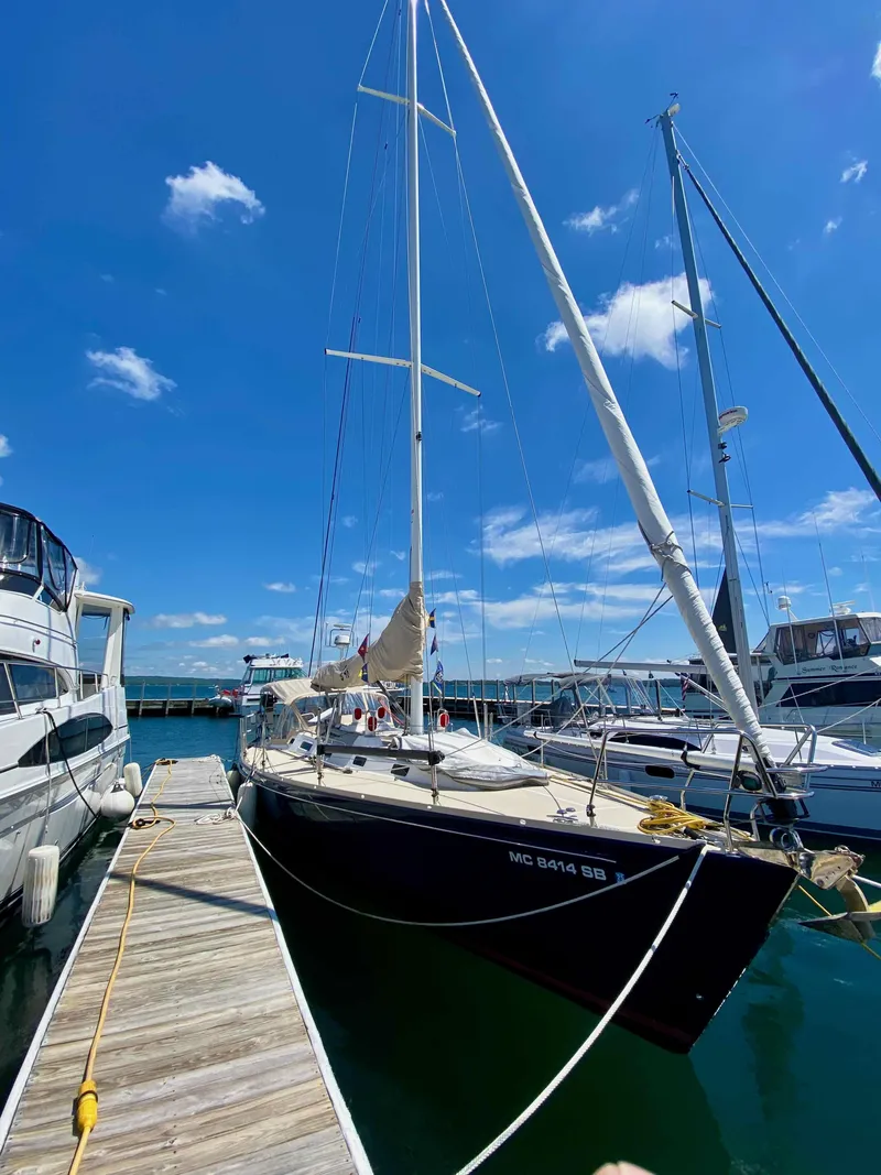 Slide: The Image of 2001 J Boats J/46 sailboat docked under a clear blue sky. - 6