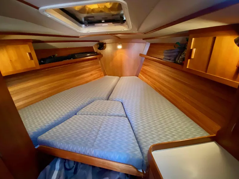 Slide: The Image of Cozy cabin interior of 2001 J Boats J/46 with wooden finish and comfortable bedding. - 9