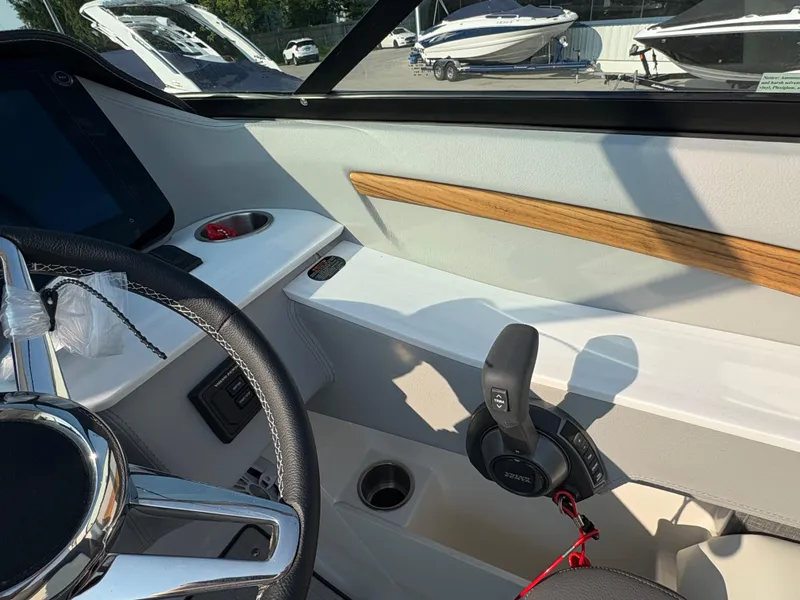 Slide: The Image of Interior view of 2025 Regal LS9 Surf boat cockpit with steering wheel and controls. - 21