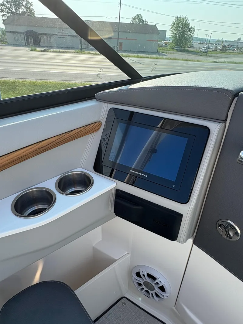 Slide: The Image of 2025 Regal LS9 Surf boat interior with touchscreen display and cup holders. - 27