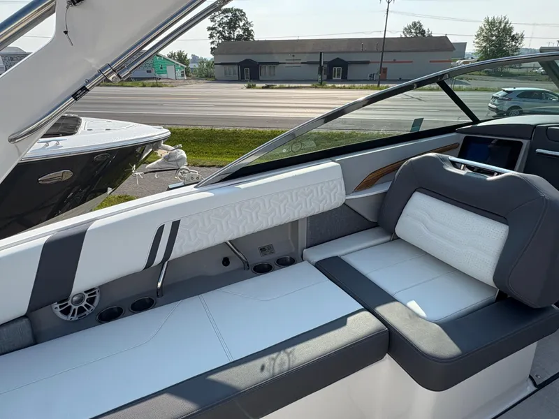 Slide: The Image of 2025 Regal LS9 Surf boat interior with sleek white and gray seating. - 29
