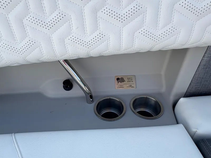 Slide: The Image of 2025 Regal LS9 Surf boat interior with cup holders and white upholstery. - 30