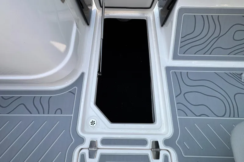 Slide: The Image of 2025 Regal LS9 Surf boat deck with storage compartment and textured flooring. - 41