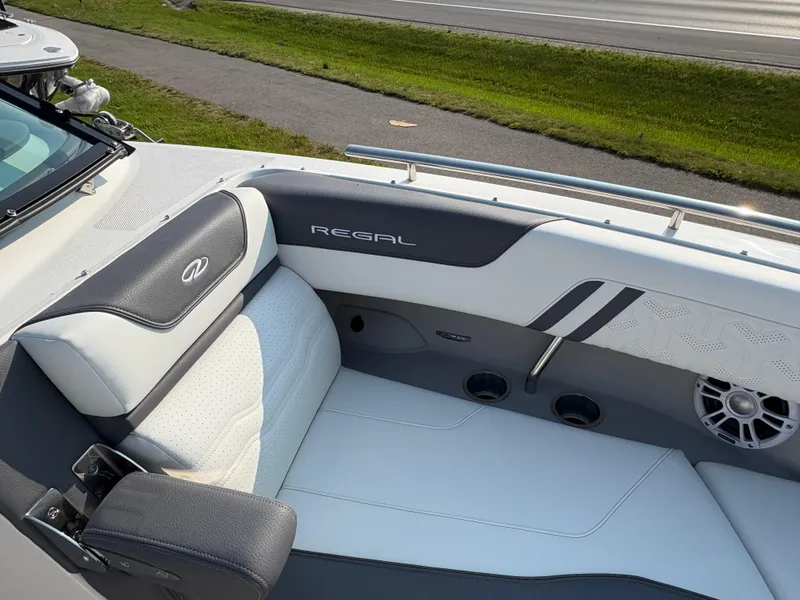 Slide: The Image of 2025 Regal LS9 Surf boat interior with white and gray seating. - 7