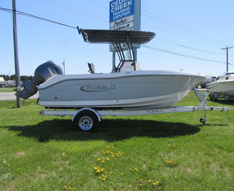 The Image of 2025 Robalo R180 Center Console boat on trailer, displayed outdoors. - 0