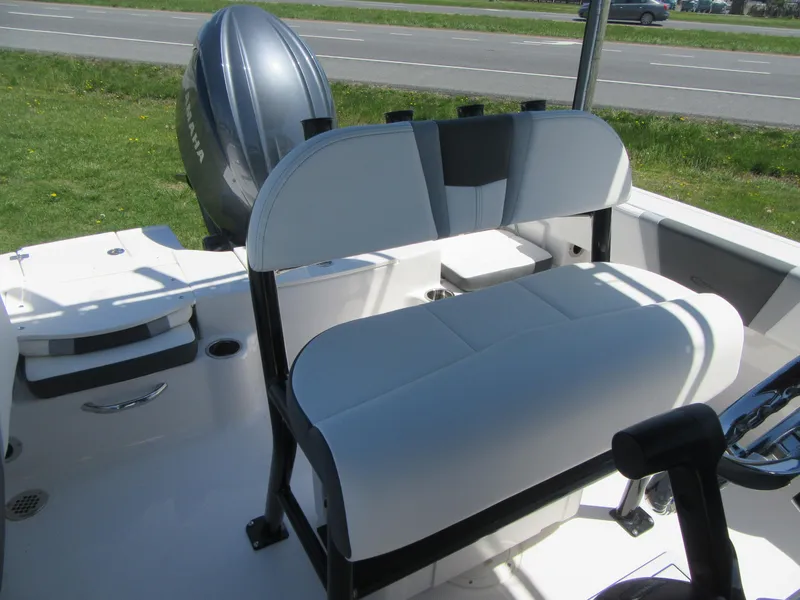 Slide: The Image of 2025 Robalo R180 Center Console boat interior with seating and Yamaha outboard motor. - 12