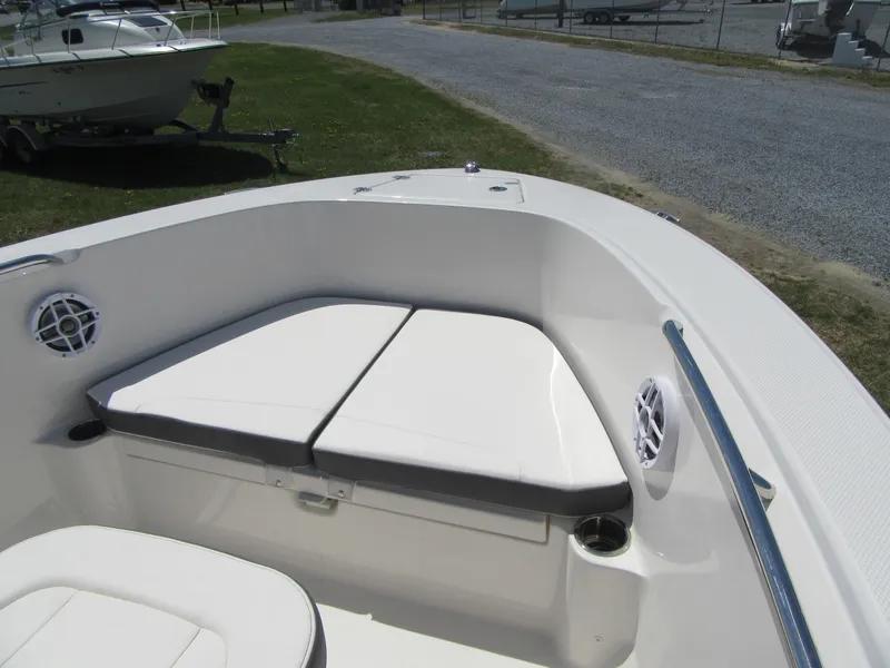 Slide: The Image of 2025 Robalo R180 Center Console boat interior with cushioned seating and storage. - 4