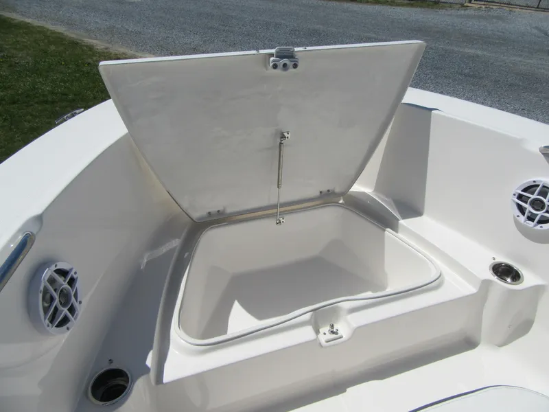 Slide: The Image of 2025 Robalo R180 Center Console boat storage compartment open, showcasing interior space. - 6