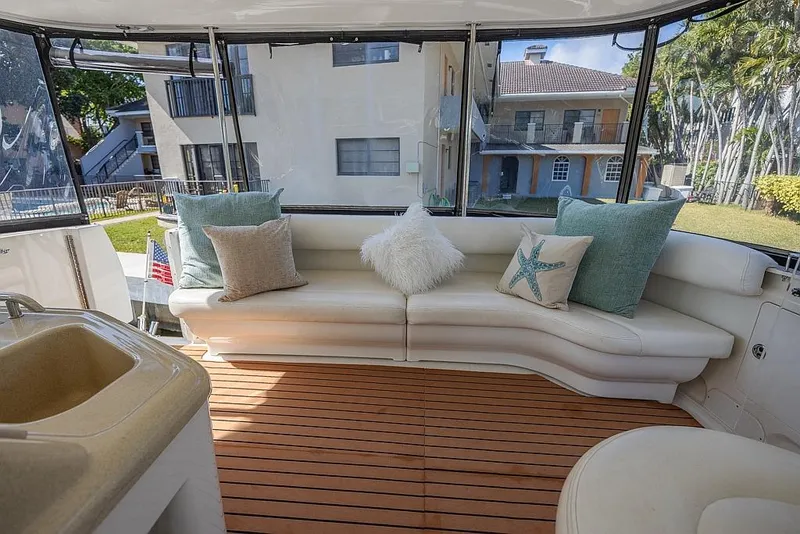 Slide: The Image of 2005 Sea Ray 390 Motor Yacht interior with plush seating and decorative pillows. - 10