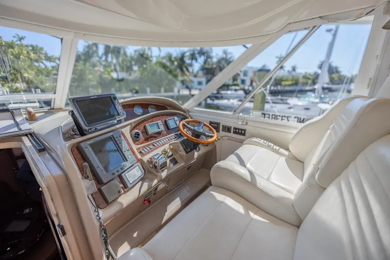 Slide: The Image of 2005 Sea Ray 390 Motor Yacht helm with modern navigation equipment and plush seating. - 11