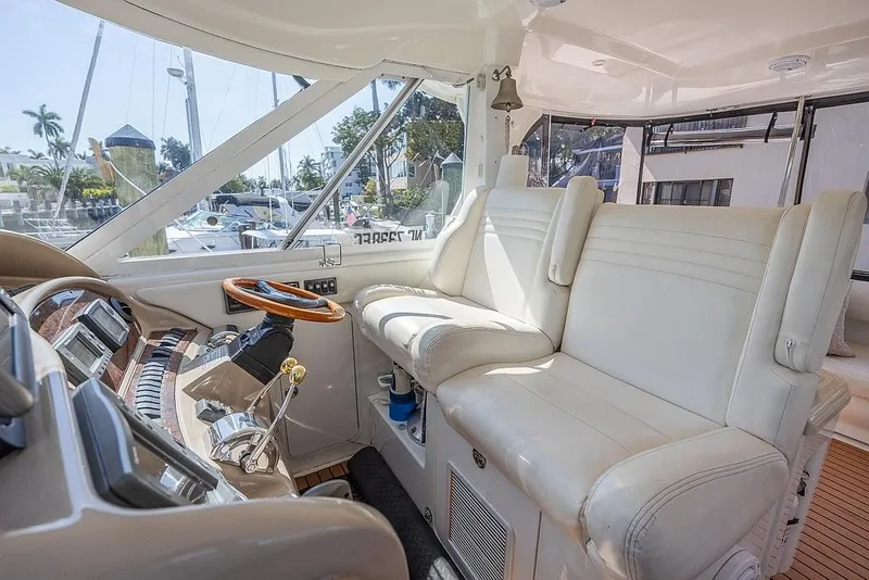 Slide: The Image of 2005 Sea Ray 390 Motor Yacht interior with white leather seating and modern controls. - 12