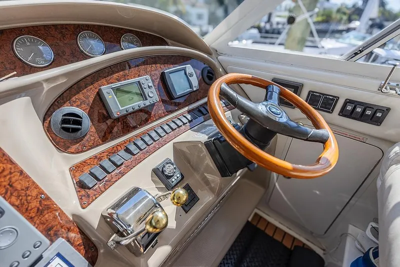 Slide: The Image of 2005 Sea Ray 390 Motor Yacht helm with wood accents and modern navigation instruments. - 14