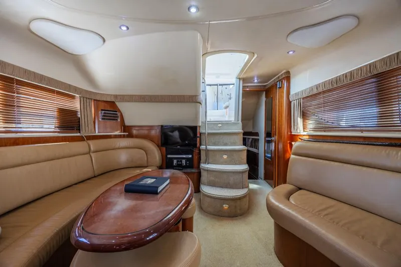 Slide: The Image of Luxurious interior of 2005 Sea Ray 390 Motor Yacht with elegant seating and wooden accents. - 16
