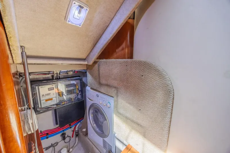 Slide: The Image of Laundry area in 2005 Sea Ray 390 Motor Yacht with washer and electrical panel. - 19