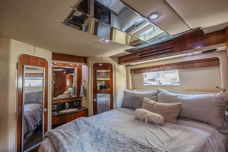 Slide: The Image of Luxurious bedroom interior of 2005 Sea Ray 390 Motor Yacht with elegant bedding and wood accents. - 20