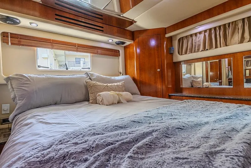 Slide: The Image of Luxurious bedroom interior of 2005 Sea Ray 390 Motor Yacht with cozy bedding. - 21