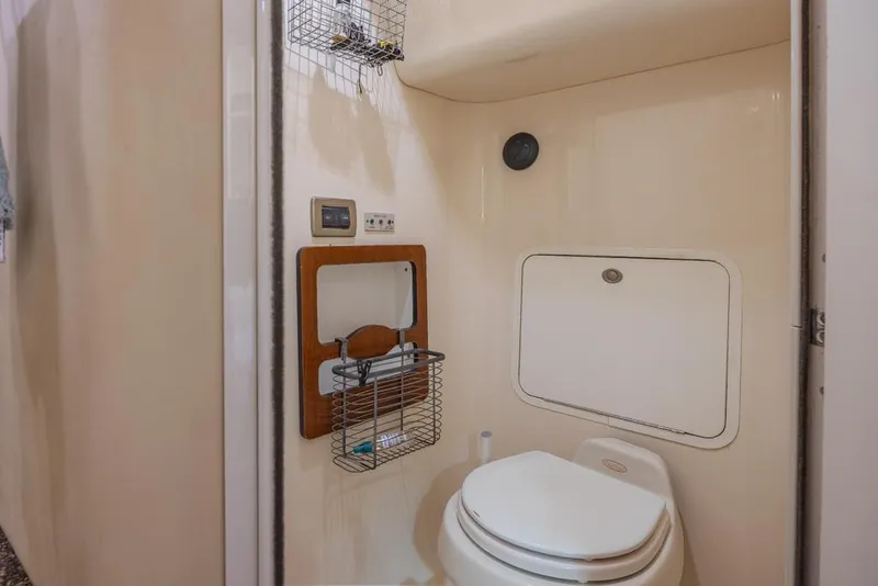 Slide: The Image of 2005 Sea Ray 390 Motor Yacht bathroom with toilet and storage features. - 25