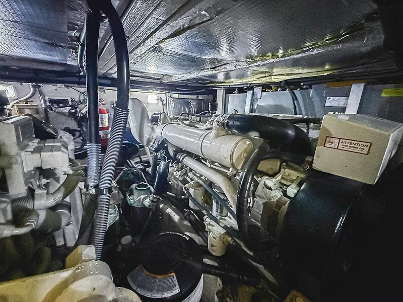 Slide: The Image of Engine room of a 2005 Sea Ray 390 Motor Yacht, showcasing mechanical components and wiring. - 27