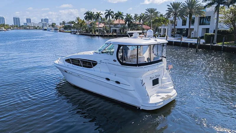 Slide: The Image of 2005 Sea Ray 390 Motor Yacht cruising on a scenic waterway with palm trees. - 4