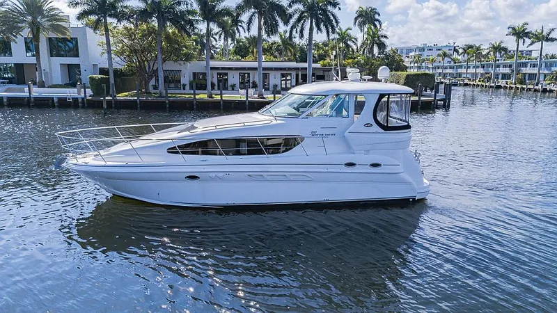 Slide: The Image of 2005 Sea Ray 390 Motor Yacht cruising on a scenic waterway with palm trees. - 5