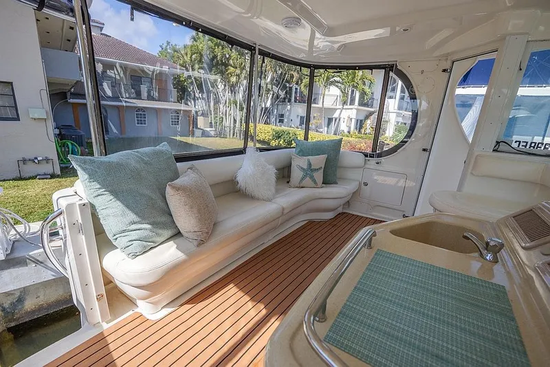 Slide: The Image of 2005 Sea Ray 390 Motor Yacht interior with plush seating and elegant wood flooring. - 7