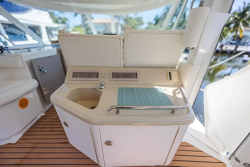 Slide: The Image of 2005 Sea Ray 390 Motor Yacht wet bar with sink and cutting board on deck. - 9