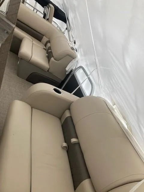 Slide: The Image of 2023 Sun Tracker PB 22 RF boat interior with beige seating. - 16