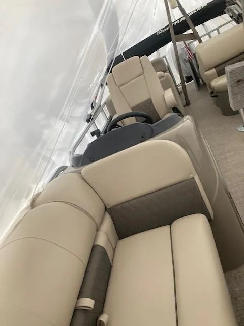 Slide: The Image of 2023 Sun Tracker PB 22 RF pontoon boat interior with beige seating. - 5