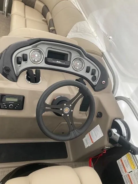 Slide: The Image of 2023 Sun Tracker PB 22 RF boat dashboard with steering wheel and controls. - 8