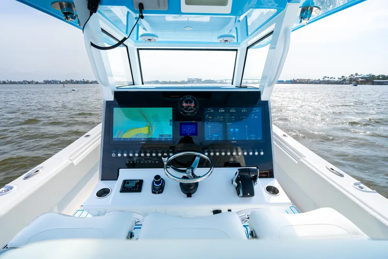 Slide: The Image of Cockpit of 2025 Insetta 35IFC boat with advanced navigation system on open water. - 10
