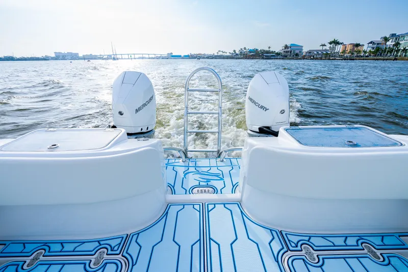 Slide: The Image of 2025 Insetta 35IFC boat with dual Mercury engines on a sunny day. - 12