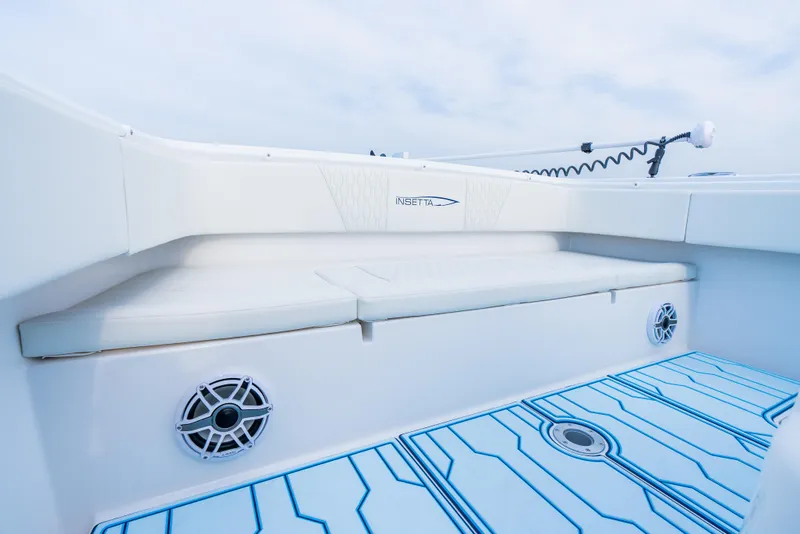 Slide: The Image of 2025 Insetta 35IFC boat interior with white seating and blue-accented flooring. - 7