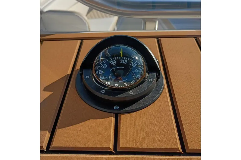 Slide: The Image of Compass on Bulls Bay 255 Center Console boat, 2026 model, with wooden panel background. - 15