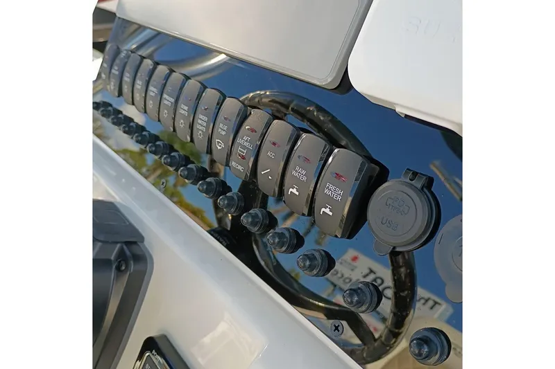 Slide: The Image of Control panel of 2026 Bulls Bay 255 Center Console boat with various switches and USB port. - 19