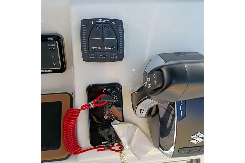 Slide: The Image of Control panel of 2026 Bulls Bay 255 Center Console boat with trim tab and ignition switches. - 22
