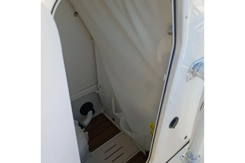 Slide: The Image of Interior view of 2026 Bulls Bay 255 Center Console boat cabin with wooden flooring. - 28