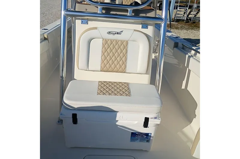 Slide: The Image of 2026 Bulls Bay 255 Center Console boat interior with cushioned seating and cooler. - 37