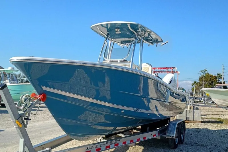 Slide: The Image of 2026 Bulls Bay 255 Center Console boat on trailer, blue hull, sunny day. - 39